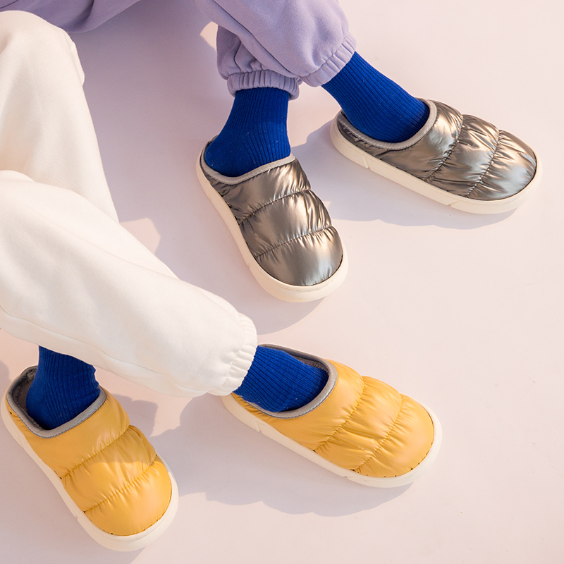Unisex puffer winter slippers worn indoors showing lightweight comfort and flexibility