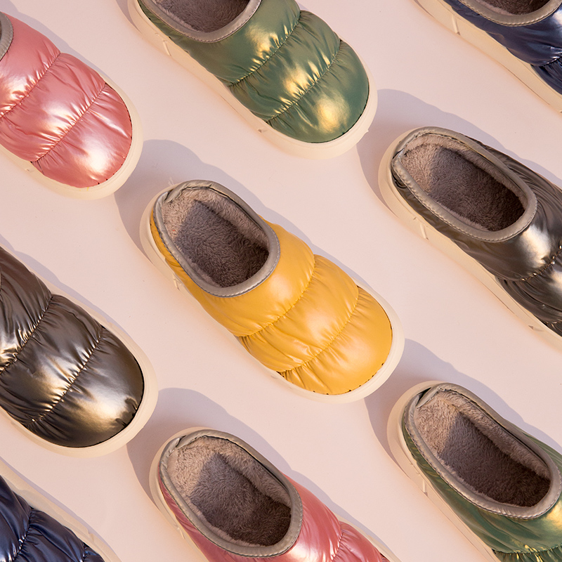 Unisex puffer winter slippers worn indoors in multiple colors