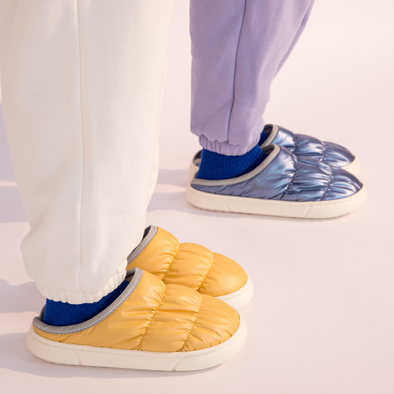 Unisex puffer winter slippers worn at home showing fit and comfort